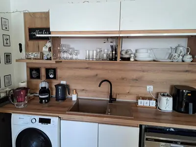 a kitchen with a sink and a washing machine at Sunny Mountain View apartment in Razlog