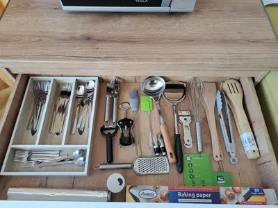 a wooden drawer filled with utensils on a table at Sunny Mountain View apartment in Razlog