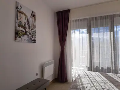 a bedroom with a bed and a window at Sunny Mountain View apartment in Razlog