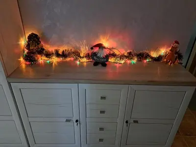 a dresser with christmas lights on top of it at Sunny Mountain View apartment in Razlog