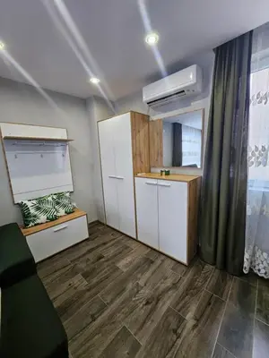 an empty room with a kitchen with wooden floors at Boutique apartment green 2 in Plovdiv
