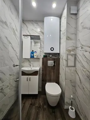 a bathroom with a toilet and a sink at Boutique apartment green 2 in Plovdiv