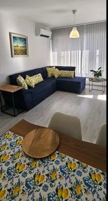 a living room with a blue couch and a table at Boutique Apartment blue 3 in Plovdiv