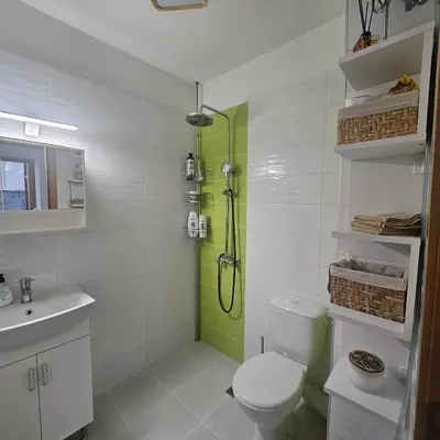 a bathroom with a shower and a toilet and a sink at Boutique Apartment blue 3 in Plovdiv