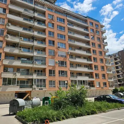 a large apartment building in front of a parking lot at Boutique Apartment blue 3 in Plovdiv