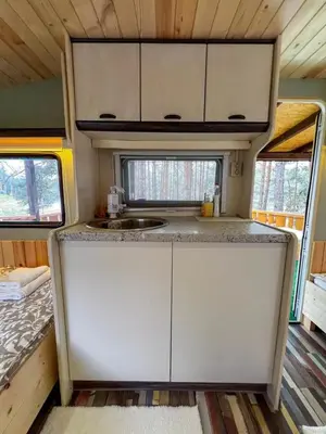 an interior view of a kitchen in a tiny house at Къмпинг Alino Lake in Alino