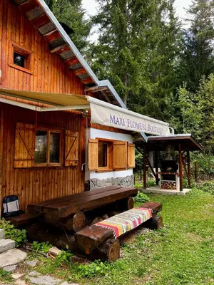 a wooden house with a bench in front of it at Вила Рози, Семково in Semkovo
