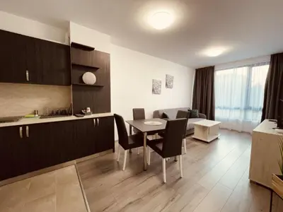 a kitchen and living room with a table and chairs at Apart2bedroomslux in Sofia