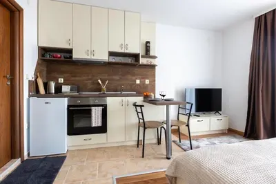 a kitchen with a table and a kitchen with a table and chairs at Divine mountain studio - parking - SPA in Bansko
