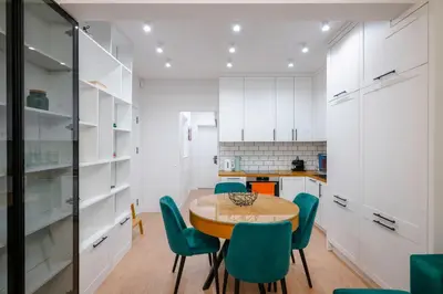 a kitchen with a wooden table and green chairs at Sunny Stylish Apartment in Sofia by Flat Mаnager in Sofia