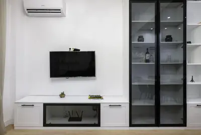a white entertainment center with a tv on a wall at Sunny Stylish Apartment in Sofia by Flat Mаnager in Sofia