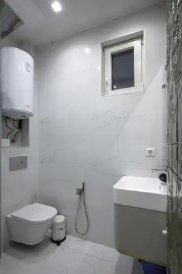 a white bathroom with a toilet and a sink at Sunny Stylish Apartment in Sofia by Flat Mаnager in Sofia