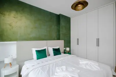 a bedroom with a large bed with green walls at Sunny Stylish Apartment in Sofia by Flat Mаnager in Sofia