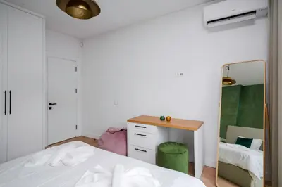 a bedroom with a bed and a mirror at Sunny Stylish Apartment in Sofia by Flat Mаnager in Sofia