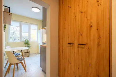 a wooden door in a kitchen with a table and chairs at Lotus apartments with free parking in Sofia