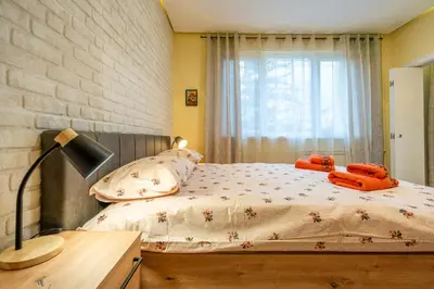a bedroom with a bed with orange towels on it at Lotus apartments with free parking in Sofia