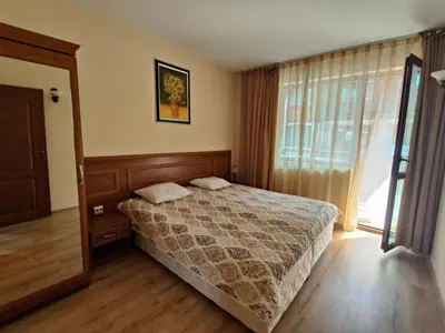 a bedroom with a bed and a large window at Fenix Emerald in Bansko