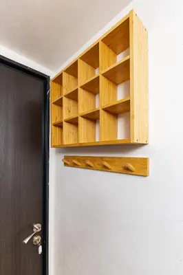 a wooden cabinet on a wall next to a door at The Crash Pad Studio by Flat Mаnager in Plovdiv