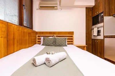 a bedroom with a large bed with towels on it at The Crash Pad Studio by Flat Mаnager in Plovdiv