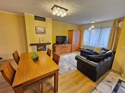 a living room with a couch and a table at Two charming Studios in Trinity Bansko with balcony and free parking by Flat Mаnager in Bansko