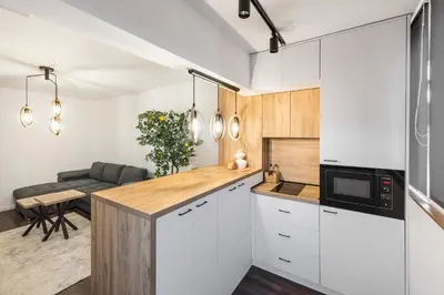 a kitchen with white cabinets and a table at AGIA 3-comfort apartment Sofia in Sofia