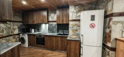 a kitchen with a refrigerator and a stove at Rhodopski Apartment in Chepelare