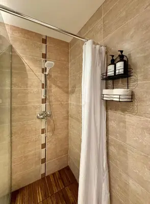a shower with a shower curtain in a bathroom at TERRA Vista Penthouse near Pirin Golf and Bansko in Razlog