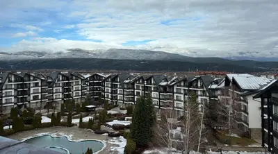 a large apartment building with snow on the ground at TERRA Vista Penthouse near Pirin Golf and Bansko in Razlog
