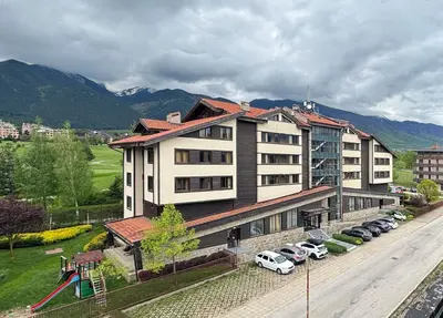 a large building with cars parked in a parking lot at TERRA Vista Penthouse near Pirin Golf and Bansko in Razlog