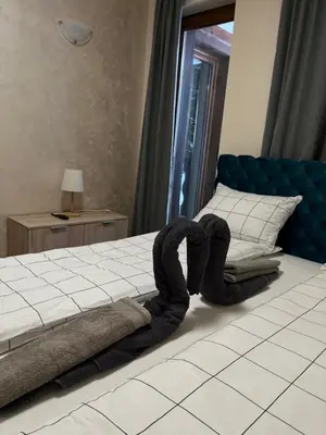a bedroom with a bed with towels on it at JMN Pamporovo in Pamporovo