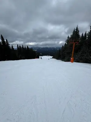 a ski slope with a cross in the snow at JMN Pamporovo in Pamporovo