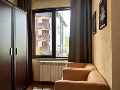 a room with two chairs and a window at Slope nest Bansko in Bansko