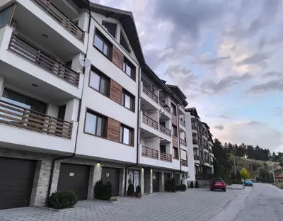 an apartment building on a cobblestone street at Апартамент Славяна in Velingrad