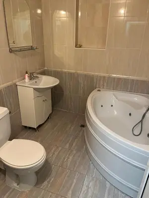 a bathroom with a tub and a toilet and a sink at Hotel MERIDA in Blagoevgrad
