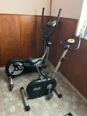 a exercise bike and an elliptical machine in a room at Hotel MERIDA in Blagoevgrad