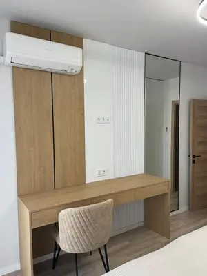 a bedroom with a desk and a mirror and a chair at Villa Vitosha Apartments in Hisarya