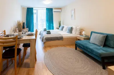 a room with a bed and a table and a couch at Silver Ridge Studio by SI Stay in Razlog