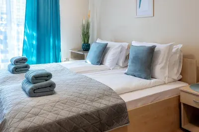 a bedroom with a bed with towels on it at Silver Ridge Studio by SI Stay in Razlog