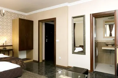 a hotel room with a bed and a bathroom at Mon Ami Apart in Studentski Grad Area in Sofia