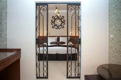 a gate leading into a bedroom with a bed at Mon Ami Apart in Studentski Grad Area in Sofia