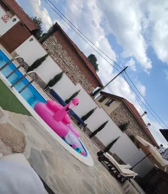 a pink skateboard sitting on the side of a pool at Вила Анжелика in Ilinden