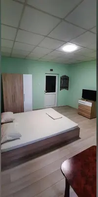 a large room with a large white bed in it at Хотел Елит in Kostinbrod