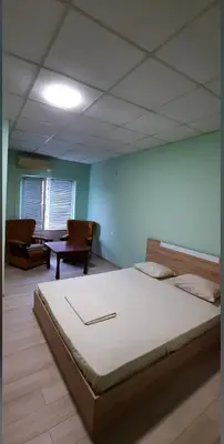 a bedroom with a large bed in a room at Хотел Елит in Kostinbrod
