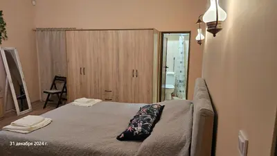a bedroom with a bed and a cabinet in it at Suite Roma 3 in Velingrad