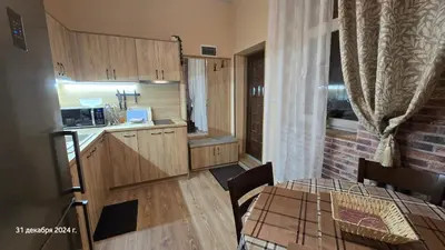 a small kitchen with a table and a dining room at Suite Roma 3 in Velingrad