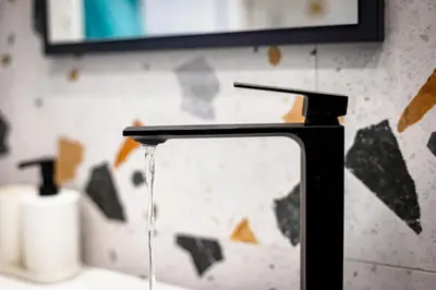 a bathroom sink with water running from a faucet at Space art apart in Sofia
