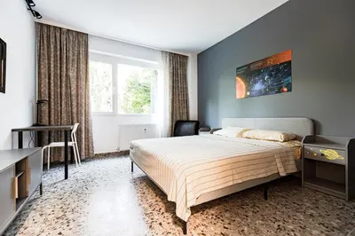 a bedroom with a bed and a large window at Space art apart in Sofia