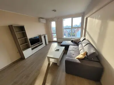 a living room with a couch and a tv at New apartment with a great view in Sofia