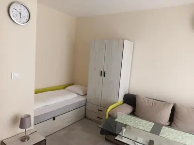 a small room with a bed and a cabinet at Апартамент тип хотелска стая in Plovdiv