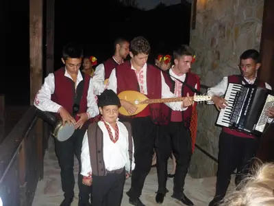 a group of men playing music and a guitar at Ognyanovata Guest House in Dobărsko